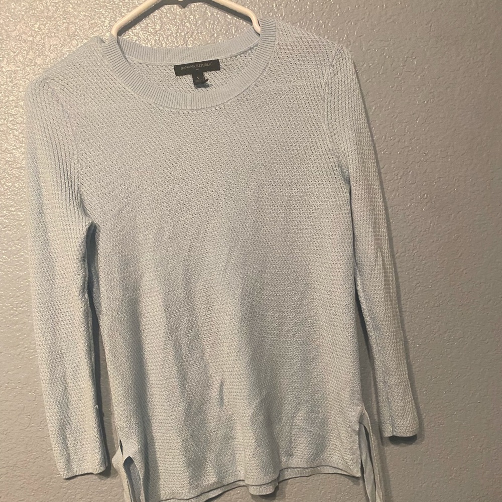 Baby blue sweatshirt with adjustable ties on the side